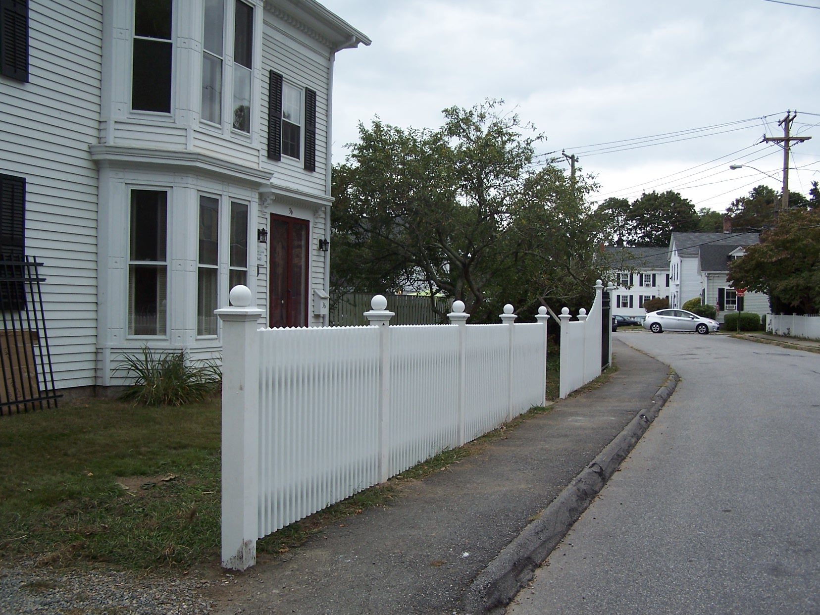 Cedar picket fence with ball caps along a front yard, Arrow Fence Inc Connecticut