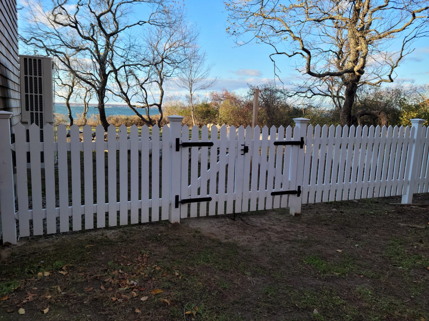 Hand-pointed Northern White Cedar picket fence with white double gate and strap hinges, Arrow Fence Inc